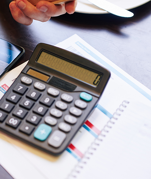Close-up image of man checking his banking account via mobile application when calculating price of trip